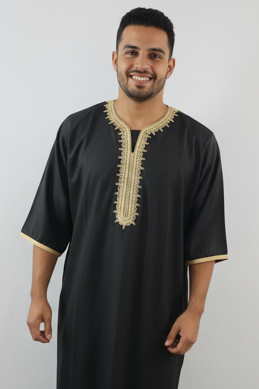 Man wearing a black traditional outfit with gold embroidery on a white background